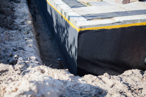 Professional Basement Waterproofing technician working in Hilton, NY